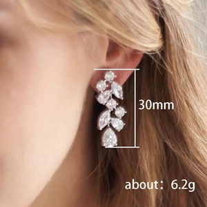 Silver long tassel petal earrings with sparkling cubic zirconia on a female model