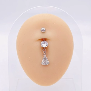 Macro shot of silver belly ring with zircon and religious pendant on a display model
