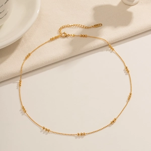 Close-up of 18K gold stainless steel bead chain necklace with K18 engraved tag