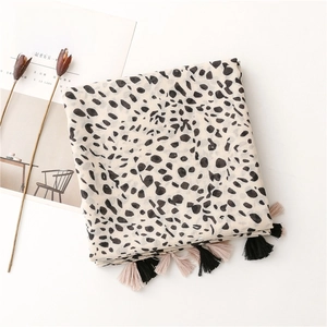 Detail of leopard print scarf with soft cotton-linen feel and decorative tassel edges