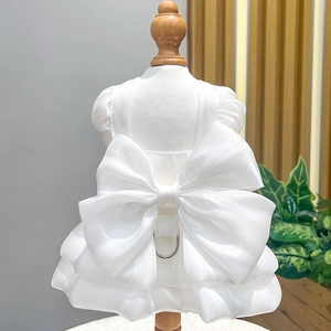 Detail of pet wedding dress showing large organza bow and metal D-ring for leash attachment