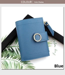 Detail of blue pebble leather short wallet with golden metal buckle and side zipper pocket