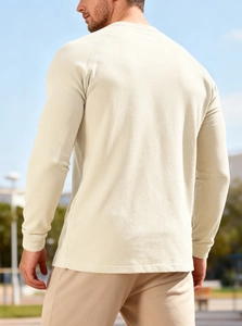 Rear view of men's waffle knit long sleeve henley shirt in beige with raglan sleeves