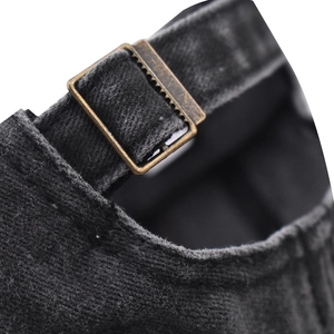 Detail of adjustable metal buckle on vintage washed cotton baseball cap back strap