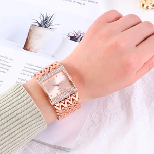 Detail of rose gold square watch with crystal accents and hollowed wave chain band