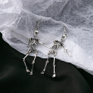 Detailed view of punk style skeleton earrings with blue mesh on velvet background