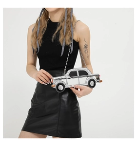 Detail of silver vintage car-shaped shoulder bag with checkerboard patterns and bead chain