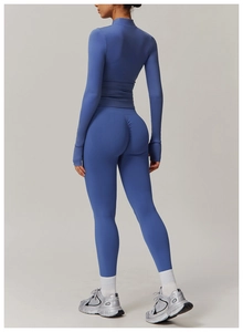 Close-up of scrunch butt detail on blue high-waisted yoga leggings and long sleeve top