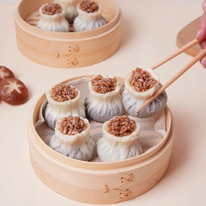 Realistic steamed shumai dumpling model in a bamboo steamer for prop display