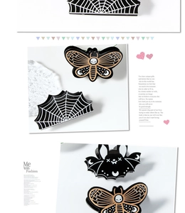 Detailed view of Gothic hair claws featuring bat, spider web and skull moth patterns