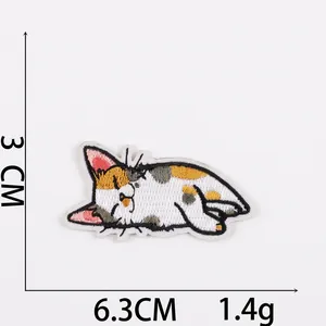 Macro view of calico cat embroidery patch showing measurements of 6.3cm by 3cm size