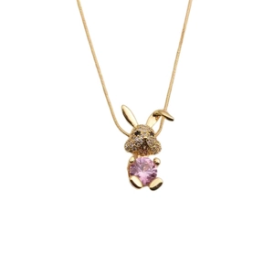 Gold necklace with diamond-encrusted rabbit pendant holding a pink round gemstone