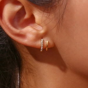 Macro shot of 18K gold plated double layered earrings with sparkling zircon inlay