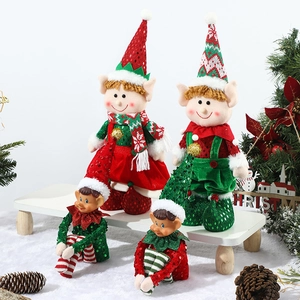 Set of 4 red and green Christmas elf figurines standing and sitting in festive decor