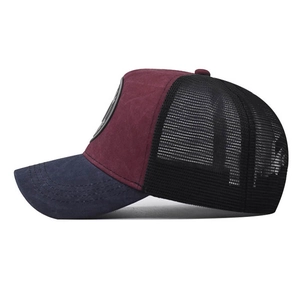 Detail of navy brim and burgundy front with breathable black mesh on a baseball cap