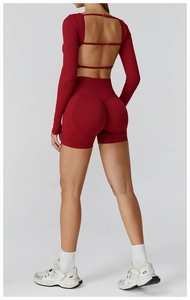 Detail of dark red seamless yoga set featuring open back lace-up top and scrunch shorts