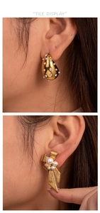 Detail of vintage gold C-shape bow and water drop earrings with micro-pearls and diamonds