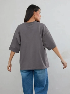 Vista posteriore di una t-shirt grigia in cotone con vestibilità ampia e spalle cadenti