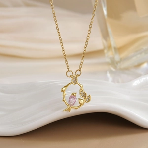 Luxurious hummingbird necklace with pink pear-shaped crystal on gold branch pendant