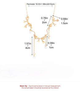 Detail view of gold bow and pearl bracelet showing 16.53+1.96in adjustable length