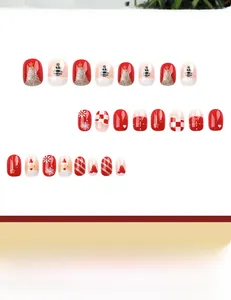 Detailed view of Christmas press-on nails featuring red and gold snowflake patterns