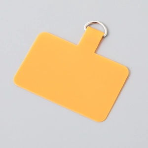 Macro view of orange TPU phone lanyard patch with durable silver metal D-ring attachment