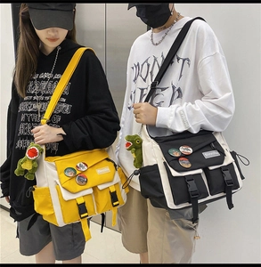 Detail shot of Japanese messenger bags in yellow and black with multi-pocket design