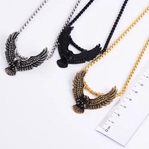 Vintage stainless steel eagle pendants in gold, silver, and black finishes with scale