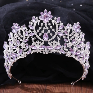 Luxury silver bridal crown featuring shimmering purple crystals and rhinestones for weddings