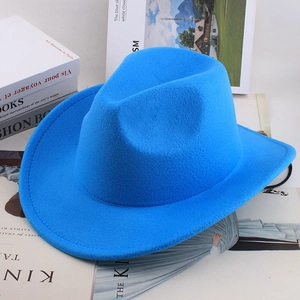 Detail of bright blue wool felt jazz hat with black drawstring on a white desk