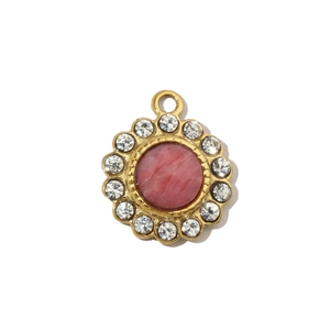 Close-up of gold pendant with pink natural stone and sparkling white diamond border