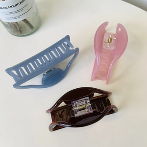 Three large matte hair claws in blue, pink, and brown for thick hair styling