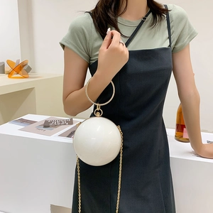 Fashionable ivory round evening clutch with pearl texture and gold ring handle