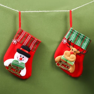 Close-up of fabric Christmas stockings with snowman, reindeer and Merry Christmas text