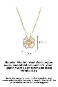 Macro detail of gold four-leaf clover necklace pendant with white cubic zirconia crystals