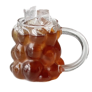 Heat-resistant borosilicate glass mug with bubble texture and clear handle for coffee