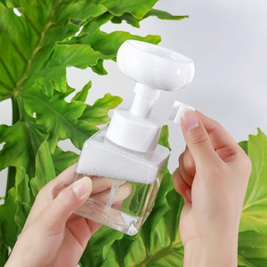 Square clear foam dispenser bottle with white flower pump and safety clip