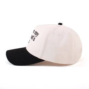Detail of side embroidery on beige and black two-tone cotton twill baseball cap