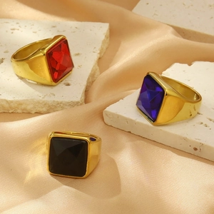 Detailed shot of titanium steel rings with large red, blue, and black square cubic zirconia