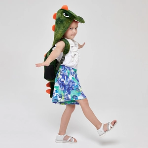 Detailed view of green dinosaur backpack with orange spikes and a matching hood on child
