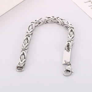Close-up of silver stainless steel Byzantine chain bracelet with blank metal tag