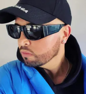 Close-up of stylish black rectangular sunglasses worn by a model in casual streetwear