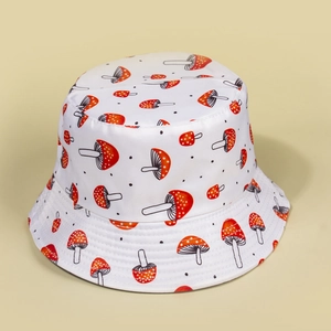 Detail of mushroom pattern and polka dots on a white cotton bucket hat for women
