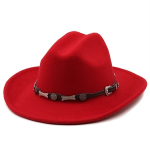 Detail of red wool cowboy hat with brown leather band and silver star rivets