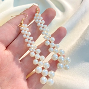 Elegant long tassel pearl earrings with multiple white pearls and golden hooks on silk