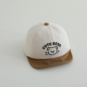Detailed close-up of a baby baseball cap with cute bear embroidery and contrast brim
