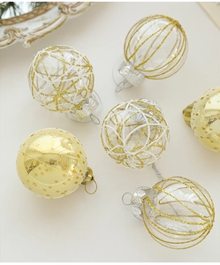 Detail view of 6cm transparent and gold Christmas balls with glitter patterns for tree decor