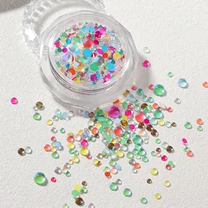 Macro shot of iridescent mermaid glass beads in assorted sizes for nail art decoration