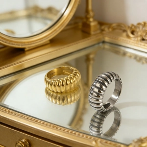 Macro detail of vintage spiral textured stainless steel rings in gold and silver finish