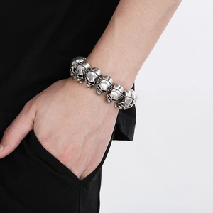Close-up of vintage silver skull bracelet showing gothic metal details on male wrist